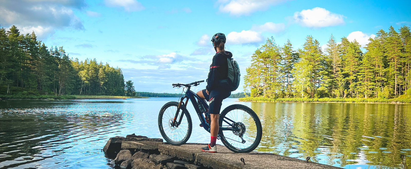 Steffi Marth steht mit E-Bike auf dem Steg in Schweden